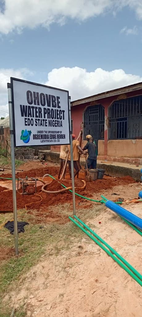 Ohovbe Water Project sign beside active borehole construction in Edo State